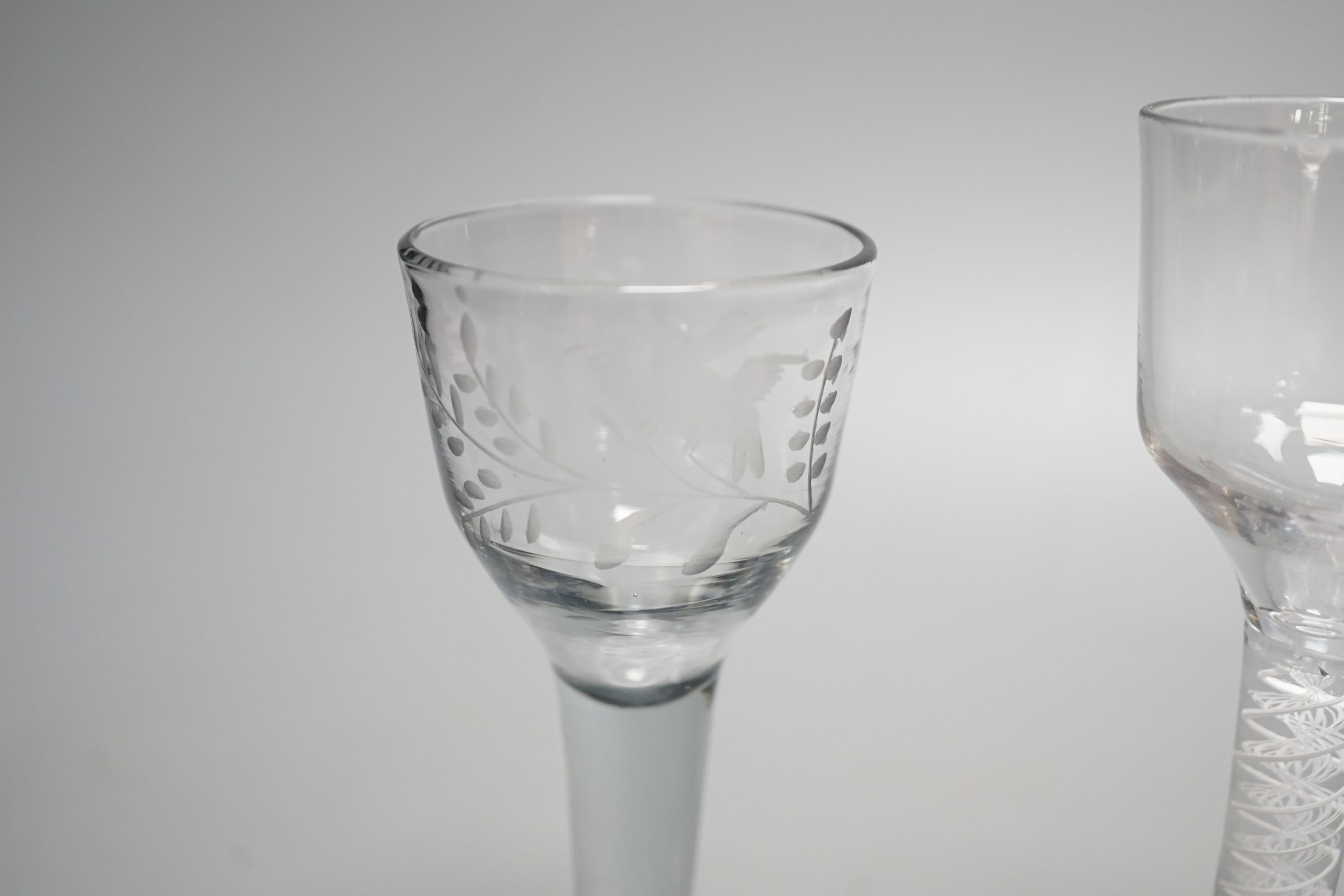 A George III opaque twist stem cordial glass, a George II cordial glass with folded foot and a wrythen twist ale glass (3) - tallest 15cm